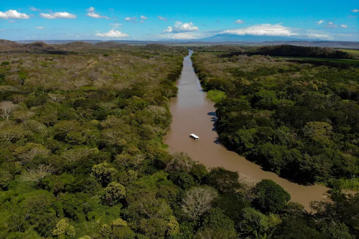 a river running through a grassy hill