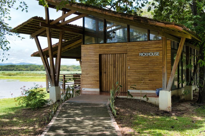 Wooden building labeled 'RICKHOUSE' by a riverside path.