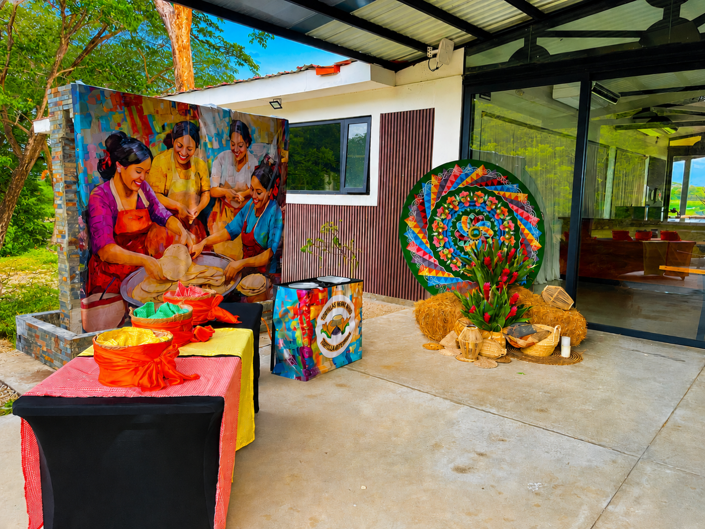 Colorful outdoor display with art, wicker baskets, and decorative arrangements.